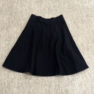 Black pleated knee length skirt